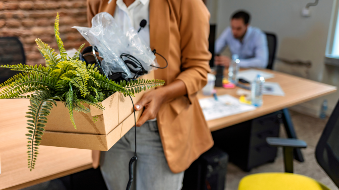 Woman carrying box with belongings office