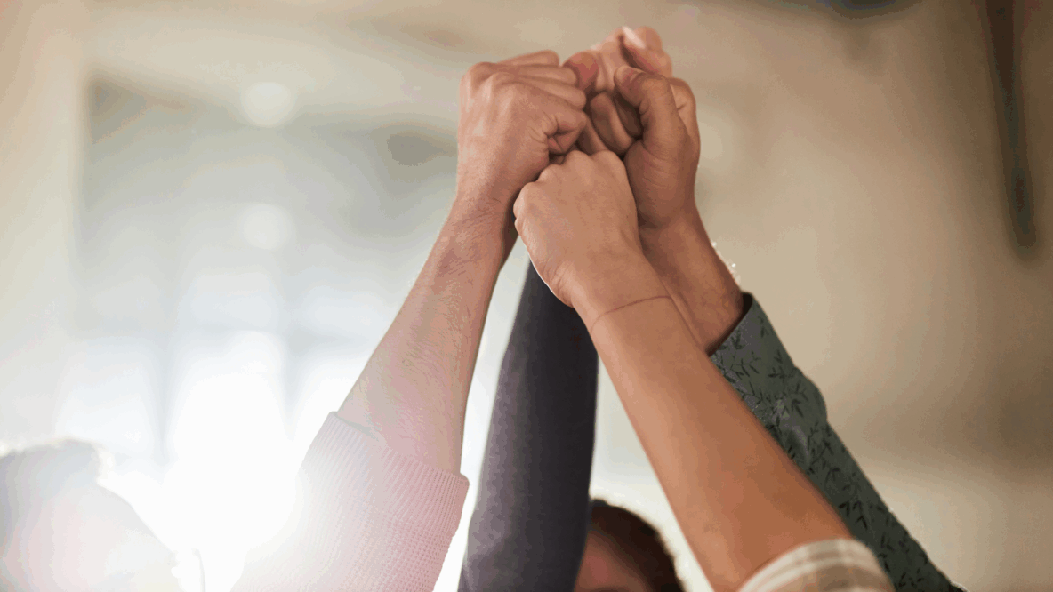 group of people fist raised office space