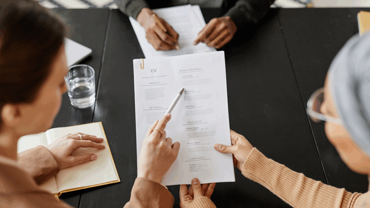 group of people holding and inspecting a CV