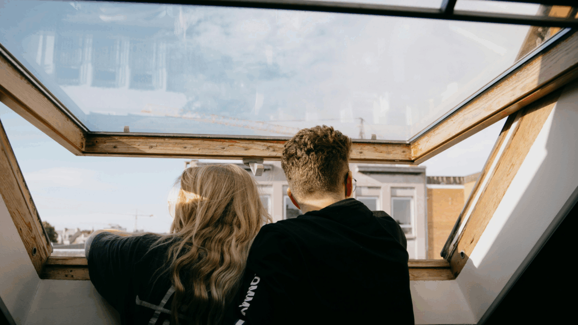 couple looking outside a window opened
