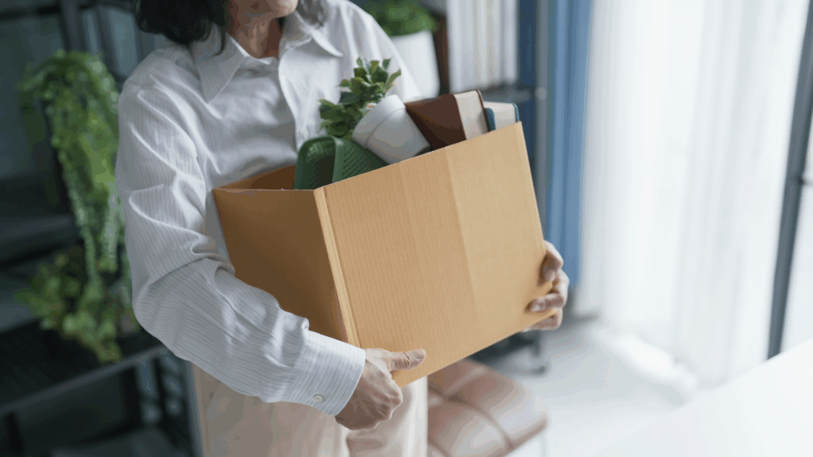 woman carrying office supplies in a box